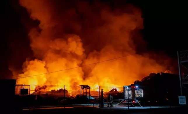 Firefighters put out a fire after Russian missiles hit a warehouse in Kyiv, Ukraine, Wednesday, Aug. 5, 2026. (AP Photo/Dan Bashakov)