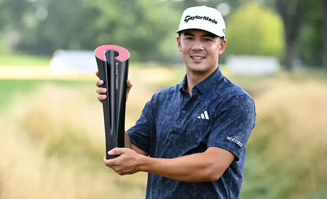 Michael Thorbjornsen poses with the trophy after winning the Rocket Classic golf tournament, Sunday, Aug. 2, 2026, in Detroit. (AP Photo/Jose Juarez)