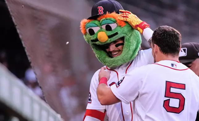 Boston Red Sox's Jarren Duran is congratulated by Caleb Durbin (5) after his solo home run during the first inning a baseball game against the Chicago White Sox, Tuesday, Aug. 4, 2026, in Boston. (AP Photo/Charles Krupa)