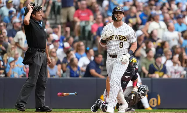 Milwaukee Brewers' Jake Bauers flips his bat after hitting a two-run home run during the third inning of a baseball game against the Atlanta Braves, Saturday, Aug. 22, 2026, in Milwaukee. (AP Photo/Aaron Gash)