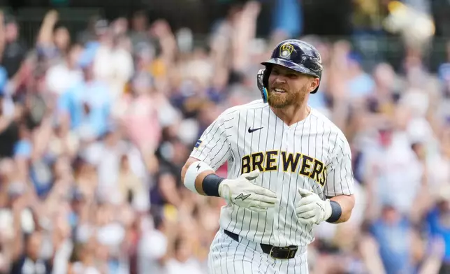 Milwaukee Brewers' Jake Bauers reacts as he rounds the bases after hitting a two-run home run during the third inning of a baseball game against the Atlanta Braves, Saturday, Aug. 22, 2026, in Milwaukee. (AP Photo/Aaron Gash)