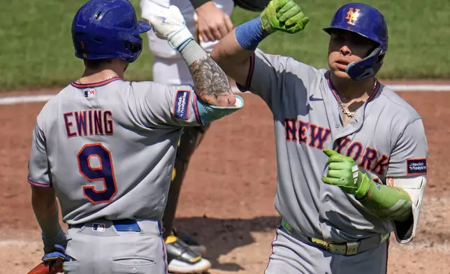 New York Mets' Francisco Alvarez, right, is greeted by A.J. Ewing (9) as he returns to the dugout after hitting a solo home run off Pittsburgh Pirates pitcher Kirby Yates during the fifth inning of a baseball game in Pittsburgh, Sunday, Aug. 9, 2026. (AP Photo/Gene J. Puskar)
