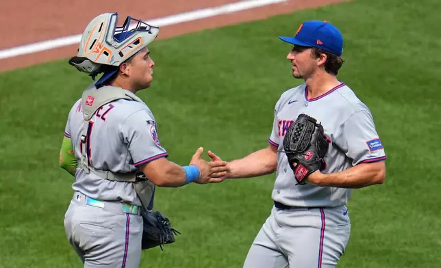 New York Mets pitcher Jack Weissenburger, right, celebrates with catcher Francisco Alvarez, left, after getting the final out of a baseball game against the Pittsburgh Pirates in Pittsburgh, Sunday, Aug. 9, 2026. (AP Photo/Gene J. Puskar)