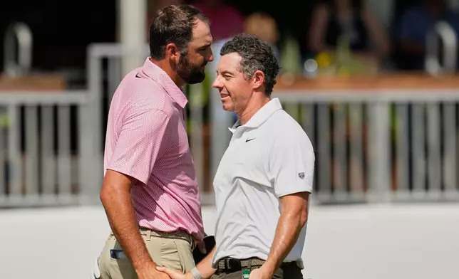 Scottie Scheffler, left, and Rory McIlroy, of Northern Ireland, shake hands after finishing the second round of the St. Jude Championship golf tournament Friday, Aug. 14, 2026, in Memphis, Tenn. (AP Photo/George Walker IV)