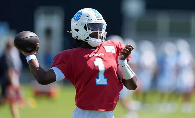 Tennessee Titans quarterback Cam Ward (1) looks to throw a pass during the NFL football team's training camp Tuesday, Aug. 25, 2026, in Nashville, Tenn. (AP Photo/George Walker IV)