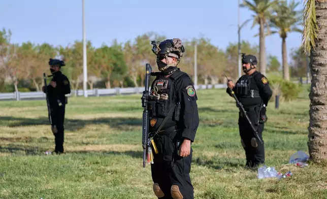 Iraqi security officers stand guard at the site near Baghdad International Airport where Iranian military commander Qassem Soleimani was killed in a U.S. drone strike, during a visit by Iranian Parliament Speaker Mohammad Baqer Qalibaf in Baghdad, Iraq, Wednesday, Aug. 19, 2026. (AP Photo/Hadi Mizban)