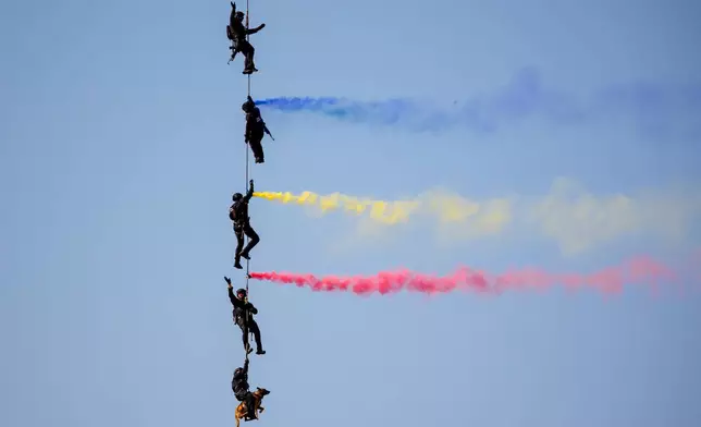 A Romanian police special unit (SIAS) along with Socks the dog perform a tactical intervention demonstration at the BIAS International Air Show, in Bucharest, Romania, Saturday, Aug. 29, 2026. (AP Photo/Andreea Alexandru)