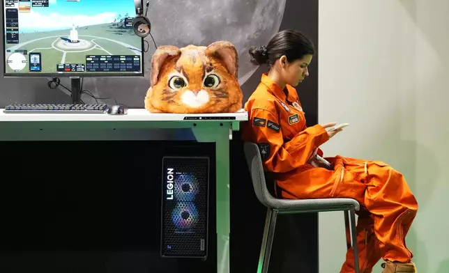 A cosplayer takes a break during the opening of Gamescom, the world's biggest gaming event and most important business platform for the international games industry, at the fair halls in Cologne, Germany, Wednesday, Aug. 26, 2026. (AP Photo/Martin Meissner)
