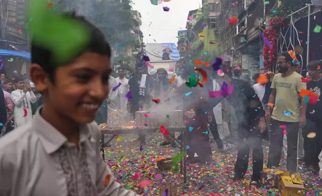 Indian Muslims release confetti during a procession marking Eid-e-Milad, the anniversary of the birth of Prophet Muhammad, in Mumbai, India, Wednesday, Aug. 26, 2026. (AP Photo/Rafiq Maqbool)