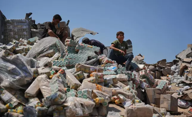 Palestinians look at a food-aid warehouse damaged in an Israeli airstrike that targeted a nearby house in Deir al-Balah, central Gaza Strip, Wednesday, Aug. 26, 2026. (AP Photo/Abdel Kareem Hana)