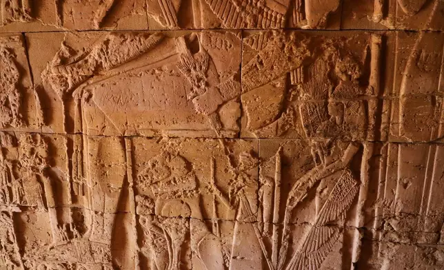 Ancient carved reliefs decorate the interior wall of a pyramid chapel at the Meroe archaeological site in Bejrawiya, Sudan, Saturday, Aug. 1, 2026. (AP Photo/Mohnd Blal)