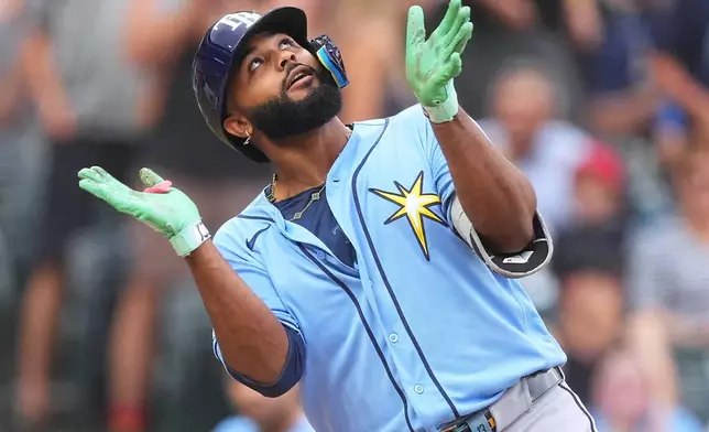 Tampa Bay Rays' Junior Caminero celebrates as he crosses home plate after hitting a two-run home run off Colorado Rockies starting pitcher Michael Lorenzen in the first inning of a baseball game Monday, Aug. 3, 2026, in Denver. (AP Photo/David Zalubowski)