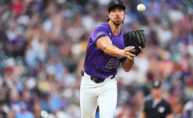 Colorado Rockies starting pitcher Michael Lorenzen turns to make a pickoff throw in the second inning of a baseball game against the Tampa Bay Rays, Monday, Aug. 3, 2026, in Denver. (AP Photo/David Zalubowski)