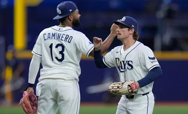 Tampa Bay Rays' Jonny DeLuca celebrates with third baseman Junior Caminero (13) after the team defeated the Baltimore Orioles during a baseball game Monday, Aug. 17, 2026, in St. Petersburg, Fla. (AP Photo/Chris O'Meara)