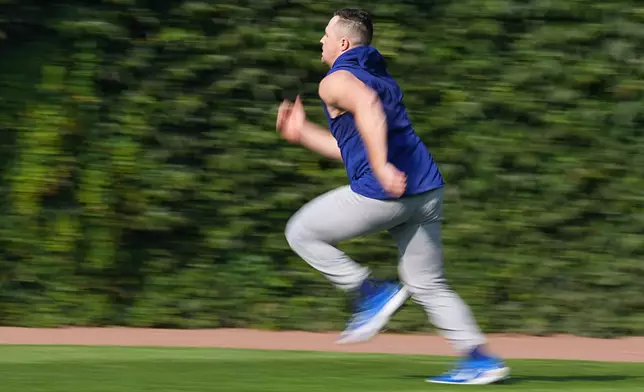 Los Angeles Dodgers pitcher Tarik Skubal runs in the outfield before a baseball game against the Chicago Cubs, Monday, Aug. 3, 2026, in Chicago. (AP Photo/David Banks)