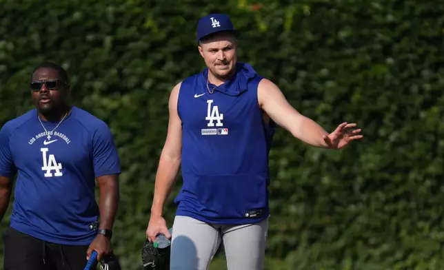 Los Angeles Dodgers pitcher Tarik Skubal, right, waves to fans before a baseball game against the Chicago Cubs, Monday, Aug. 3, 2026, in Chicago. (AP Photo/David Banks)