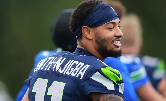 Seattle Seahawks wide receiver Jaxon Smith-Njigba looks on during the NFL football team's training camp, Saturday, Aug. 1, 2026, in Renton, Wash. (AP Photo/Lindsey Wasson)