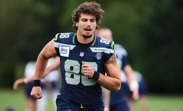 Seattle Seahawks tight end AJ Barner warms up during the NFL football team's training camp, Saturday, Aug. 1, 2026, in Renton, Wash. (AP Photo/Lindsey Wasson)