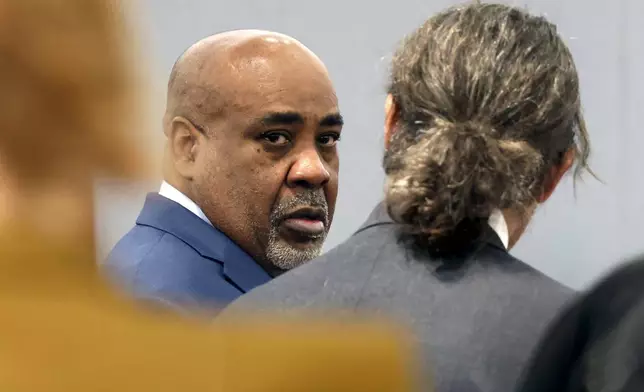 Duane Davis, center, chats with his attorney Michael Sanft during the fourth day of jury selection for his murder trial in Clark County District Court at the Regional Justice Center on Thursday, Aug. 13, 2026, in Las Vegas. Davis was indicted on murder charges for his involvement in the killing of rapper Tupac Shakur in 1996. (Bizuayehu Tesfaye/Las Vegas Review-Journal via AP, Pool)