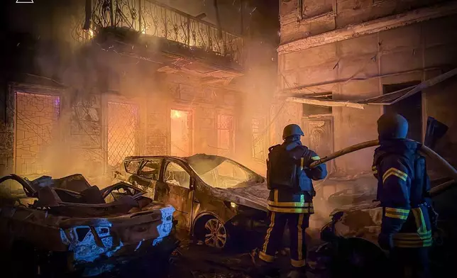 In this photo provided by the Ukrainian Emergency Service, emergency services personnel work to extinguish a fire of residential buildings following a Russian missiles attack in Odesa, Ukraine, Sunday, Aug. 9, 2026. (Ukrainian Emergency Service via AP)