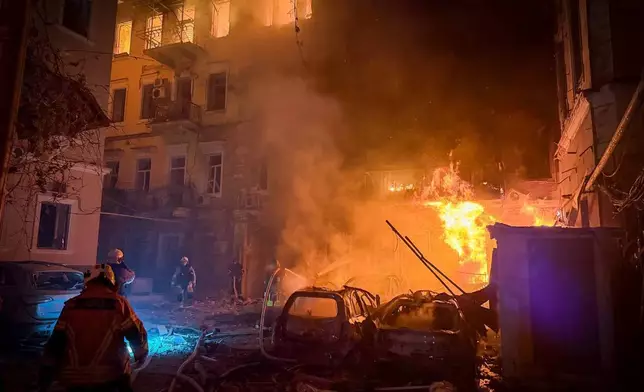 In this photo provided by the Ukrainian Emergency Service, emergency services personnel work to extinguish a fire of residential buildings following a Russian missiles attack in Odesa, Ukraine, Sunday, Aug. 9, 2026. (Ukrainian Emergency Service via AP)
