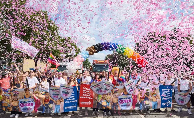 Under the rainbow, from left to right: Member of the Bundestag; Matthias Miersch (SPD), Chair of the SPD parliamentary group in the Bundestag; Katharina Fegebank (Greens), Second Mayor of Hamburg; Oliver Greve, Hamburg Pride e.V.; and Olivia Jones, drag queen; along with other participants, stand on Luebecker Strase at the start of the Hamburg Pride 2026 parade for Christopher Street Day (CSD), in Hamburg, Germany, Saturday Aug. 1, 2026. (Georg Wendt/dpa via AP)