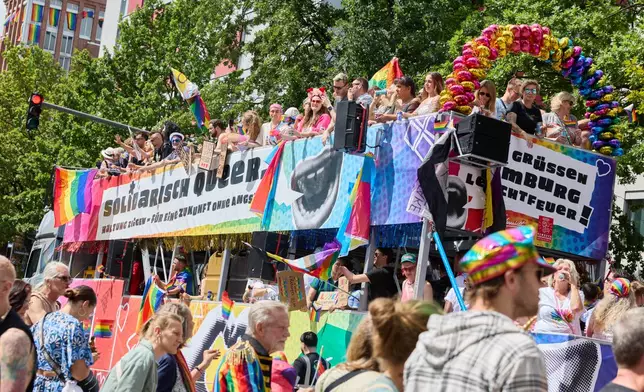 A truck from the Schmidt Theater bearing the CSD slogan "Queer in Solidarity. Take a Stand—for a Future Without Fear!" drives down Steindamm during Hamburg Pride 2026, the Christopher Street Day (CSD) parade, in Hamburg, Germany, Saturday Aug. 1, 2026. (Georg Wendt/dpa via AP)
