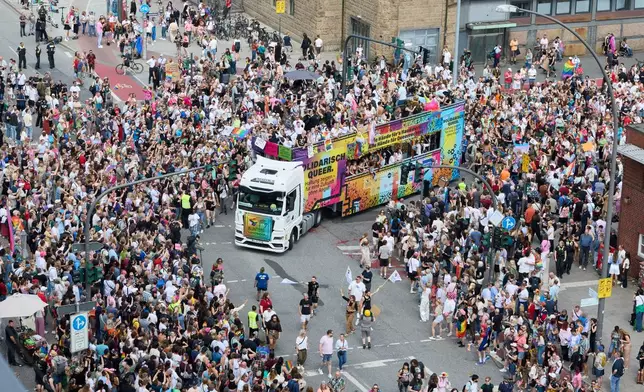 A truck drives down Steintordamm during Hamburg Pride 2026, the Christopher Street Day (CSD) parade, in Hamburg, Germany, Saturday Aug. 1, 2026. (Georg Wendt/dpa via AP)