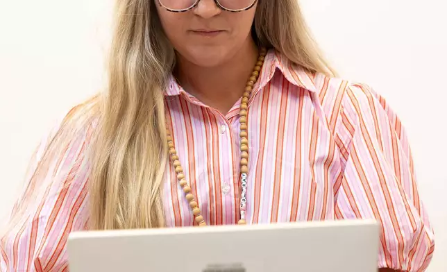 Preschool teacher Melissa Mowbray works with AI on her laptop at Academic Magnet High School during the Charleston County School District Charleston Educator Symposium Wednesday, July 22, 2026, in North Charleston, S.C. (AP Photo/Mic Smith)