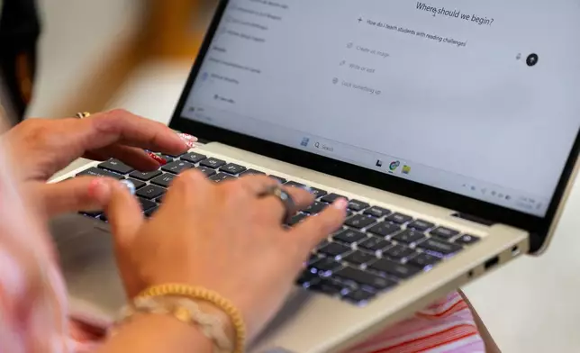 Preschool teacher Melissa Mowbray works with AI on her laptop at Academic Magnet High School during the Charleston County School District Charleston Educator Symposium Wednesday, July 22, 2026 in North Charleston, S.C. (AP Photo/Mic Smith)
