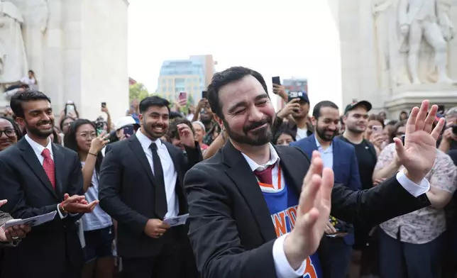 Amadeo Fusca, winner of the Zohran Mamdani look-alike contest, reacts with the crowd, Sunday, Aug. 30, 2026, in New York. (AP Photo/Heather Khalifa)