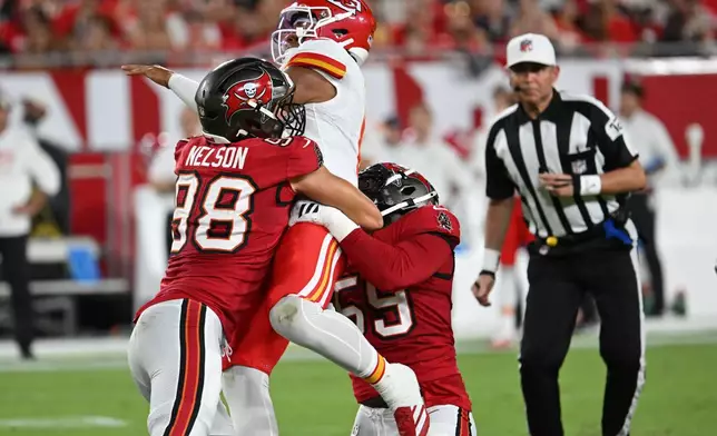 Tampa Bay Buccaneers linebacker Anthony Nelson (98) hits Kansas City Chiefs quarterback Justin Fields (6) in the first half of an NFL preseason football game, Saturday, Aug. 22, 2026, in Tampa, Fla. (AP Photo/Mark LoMoglio)
