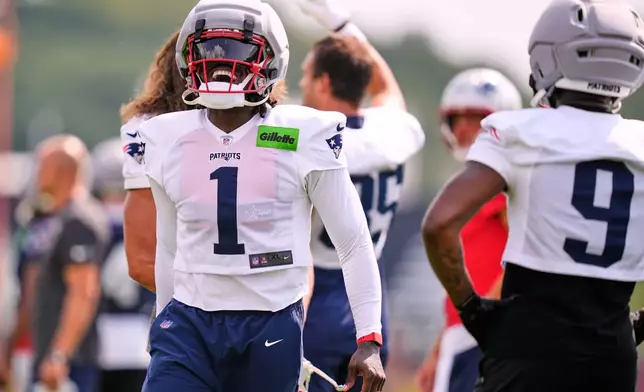New England Patriots wide receiver A.J. Brown (1) laughs with teammates during the team's NFL football training camp, Tuesday, July 28, 2026, in Foxborough, Mass. (AP Photo/Charles Krupa)