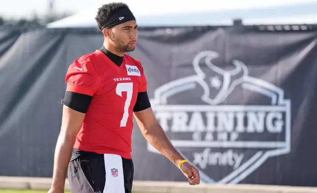 Houston Texans quarterback C.J. Stroud (7) arrives for the team's NFL football training camp in Houston, Wednesday, July 29, 2026. (AP Photo/Ashley Landis)