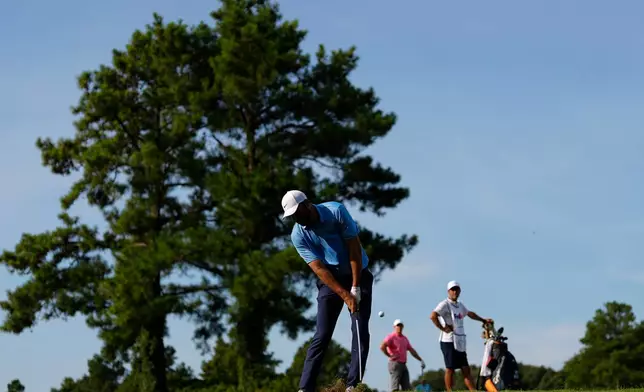 Scottie Scheffler hits on the second hole during the first round of the St. Jude Championship golf tournament, Thursday, Aug. 13, 2026, in Memphis, Tenn. (AP Photo/George Walker IV)
