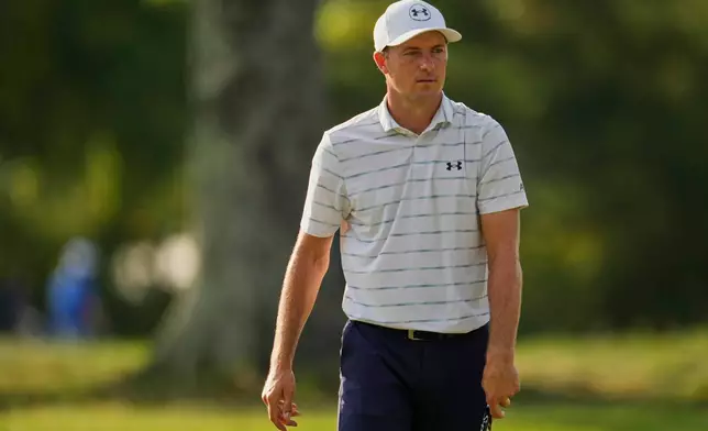 Jordan Spieth walks across the first green during the first round of the St. Jude Championship golf tournament Thursday, Aug. 13, 2026, in Memphis, Tenn. (AP Photo/George Walker IV)