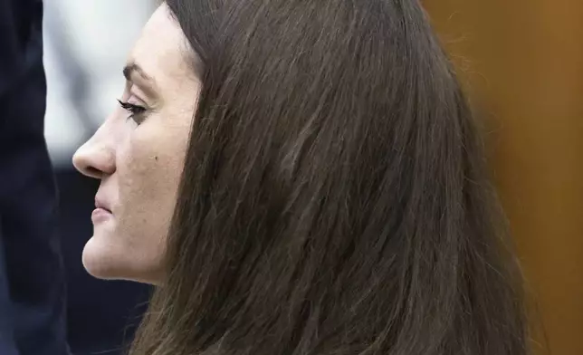 Lindsay Clancy grins after her attorney Kevin Reddington concluded his cross examination of rebuttal witness Dr. Avram Mack during her murder trial at Plymouth Superior Court, Monday, Aug. 24, 2026 in Plymouth, Mass. (Greg Derr/The Patriot Ledger via AP, Pool)