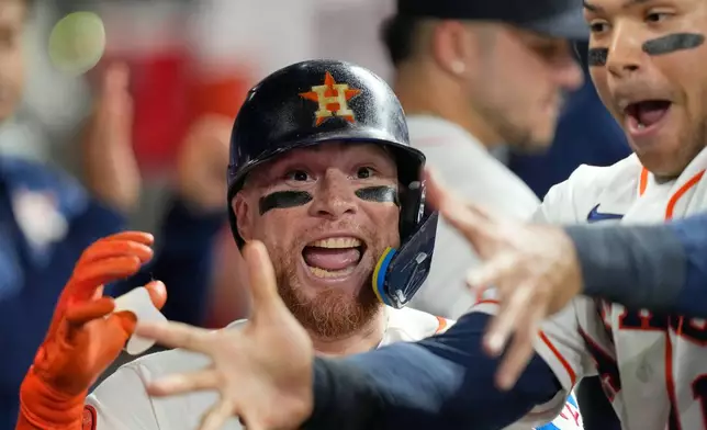 Houston Astros' Christian Vázquez, left, celebrates with Cam Smith in the dugout after hitting a home run against the Los Angeles Angels during the third inning of a baseball game Wednesday, Aug. 19, 2026, in Houston. (AP Photo/David J. Phillip)