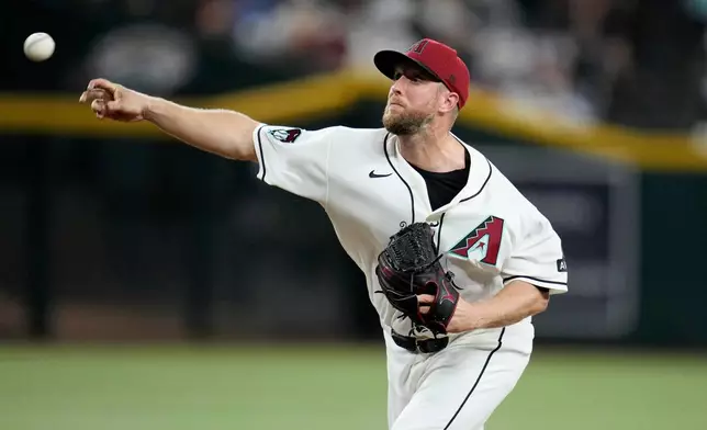 Arizona Diamondbacks starting pitcher Merrill Kelly throws against the Chicago Cubs during the first inning of a baseball game, Monday, Aug. 24, 2026, in Phoenix. (AP Photo/Ross D. Franklin)