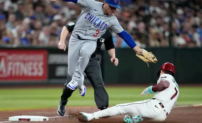 Arizona Diamondbacks' Corbin Carroll, right, steals third base as Chicago Cubs third baseman Alex Bregman (3) makes a late tag during the fourth inning of a baseball game, Monday, Aug. 24, 2026, in Phoenix. (AP Photo/Ross D. Franklin)