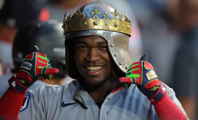 Cleveland Guardians' Angel Martínez celebrates in the dugout after his grand slam during the fifth inning of a baseball game against the Chicago White Sox, Friday, Aug. 7, 2026, in Chicago. (AP Photo/Melissa Tamez)