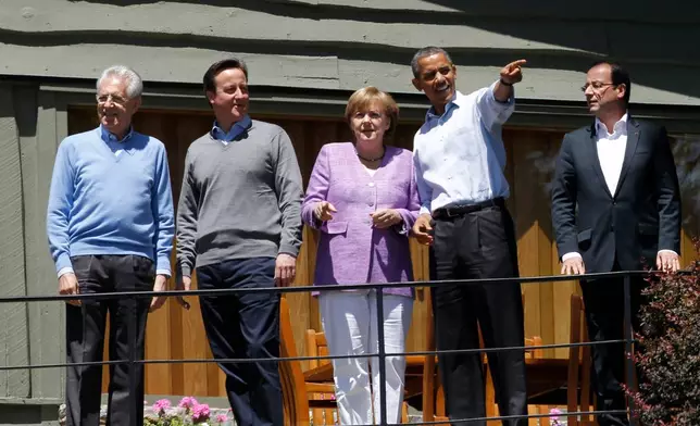FILE - From left, Italian Prime Minister Mario Monti, British Prime Minister David Cameron and German Chancellor Angela Merkel and French President Francois Hollande, right, listen as President Barack Obama shows off the grounds at the G-8 Summit Saturday, May 19, 2012 at Camp David, Md. (AP Photo/Charles Dharapak, File)