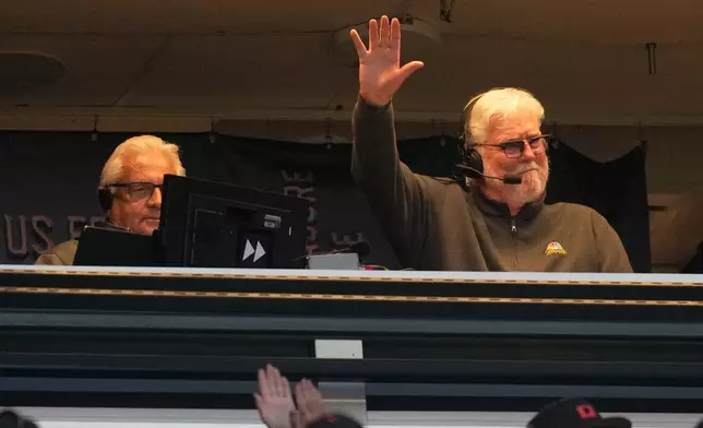 Broadcaster Mike Krukow, right, gestures toward fans next to broadcast partner Duane Kuiper after the second inning of a baseball game between the San Francisco Giants and the Detroit Tigers, Friday, Aug. 7, 2026, in San Francisco. (AP Photo/Jeff Chiu)