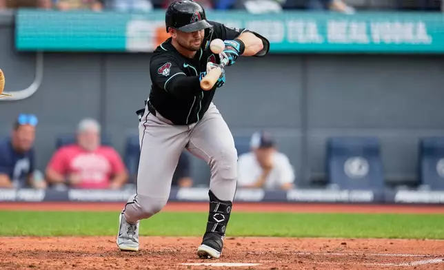Arizona Diamondbacks' Tim Tawa fouls off a bunt attempt in the sixth inning of a baseball game against the Cleveland Guardians in Cleveland, Sunday, Aug. 2, 2026. (AP Photo/Sue Ogrocki)