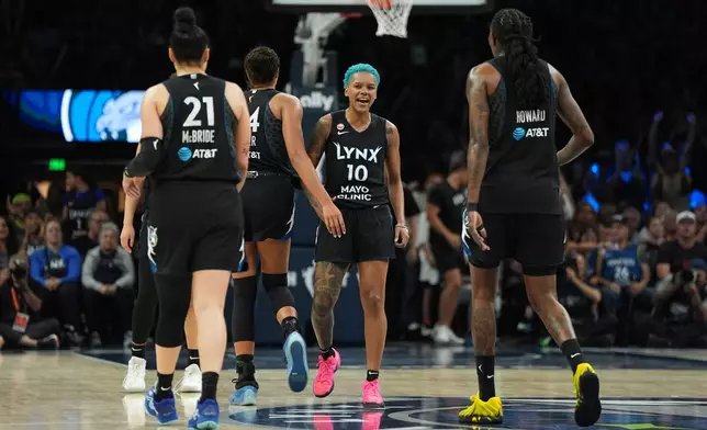 Minnesota Lynx guard Courtney Williams (10) celebrates with teammates after making a basket during the second half of a WNBA basketball game against the Indiana Fever, Sunday, Aug. 2, 2026, in Minneapolis. (AP Photo/Abbie Parr)