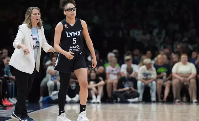 Minnesota Lynx head coach Cheryl Reeve, left, and guard Olivia Miles (5) stand on the court during the first half of a WNBA basketball game against the Indiana Fever, Sunday, Aug. 2, 2026, in Minneapolis. (AP Photo/Abbie Parr)