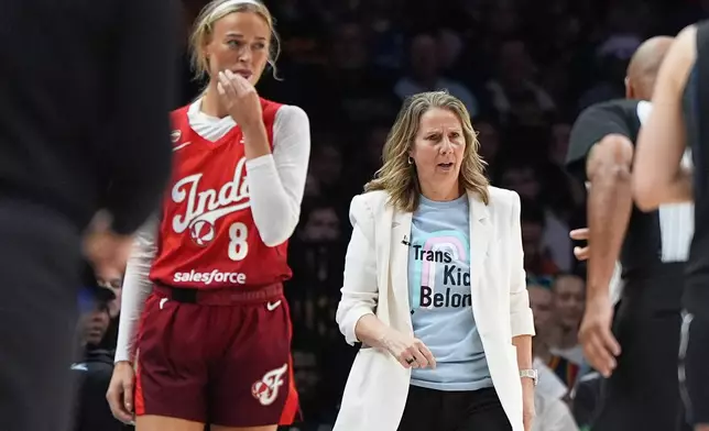 Indiana Fever guard Sophie Cunningham (8) and Minnesota Lynx head coach Cheryl Reeve, right, stand on the court during the first half of a WNBA basketball game Sunday, Aug. 2, 2026, in Minneapolis. (AP Photo/Abbie Parr)