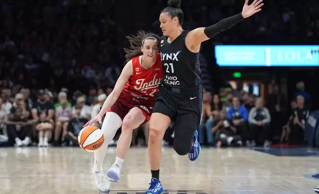 Indiana Fever guard Caitlin Clark, left, dribbles downcourt as Minnesota Lynx guard Kayla McBride (21) defends during the first half of a WNBA basketball game Sunday, Aug. 2, 2026, in Minneapolis. (AP Photo/Abbie Parr)