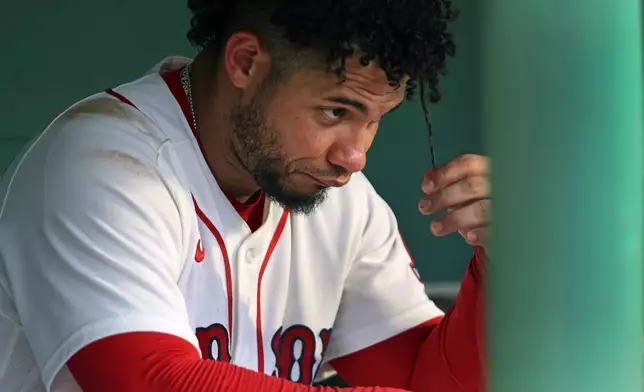 Boston Red Sox's Willson Contreras sits in the dugout after he grounded out in the eighth inning of a baseball game against the Athletics, Saturday, Aug. 8, 2026, in Boston. (AP Photo/Jim Davis)