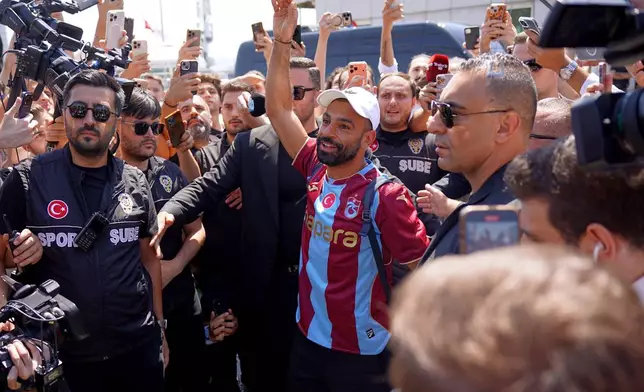 Egypt's Mohamed Salah wearing his new Trabzonspor team jersey gestures to supporters as he arrives at the airport in Istanbul, Turkey, Wednesday, Aug. 5, 2026. (Samet Yalcin/DIA Photo via AP)